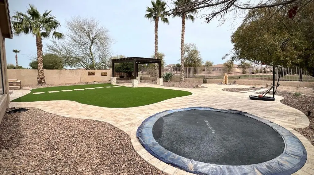 Backyard with artificial turf and pergola